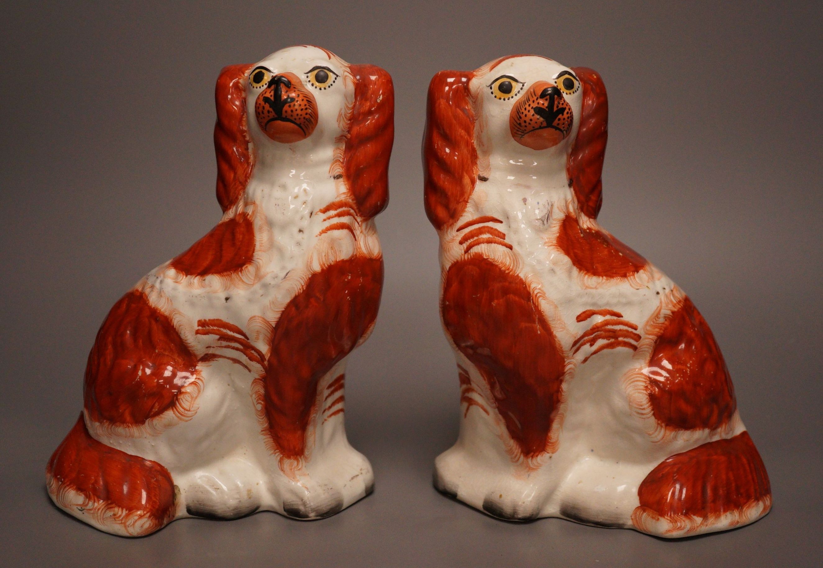 A pair of Staffordshire pottery King Charles spaniel’s, 24cm